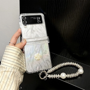 Detail of luxury silver marble phone case with 3D white rose and rhinestone pearl strap