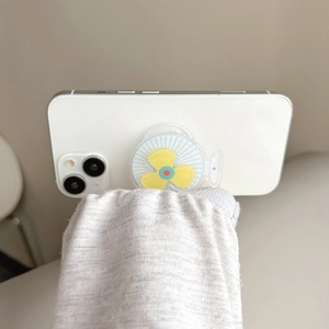 Cute rotating fan-shaped phone socket grip with yellow blades on a white smartphone