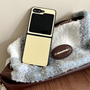 Detail showing the lychee grain leather texture of a yellow folding phone case