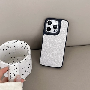 Close-up of white lychee leather phone case with black frame for iPhone 16 Pro Max