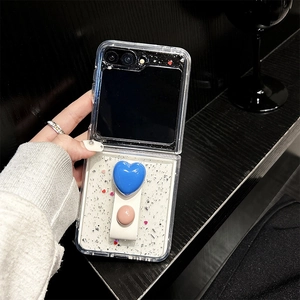 Detail of glitter case for Samsung Z Flip with blue heart stand and leather strap