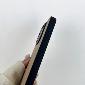 Detail view of premium beige leather phone case with matte black frame for iPhone 16 Pro Max