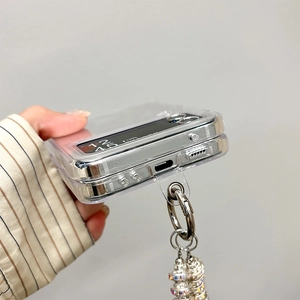 Detailed view of transparent folding phone case with silver edges and pearl chain