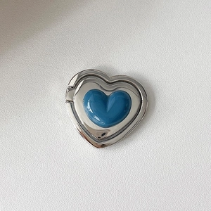 Detail view of heart-shaped mobile ring holder with silver frame and navy blue resin inlay