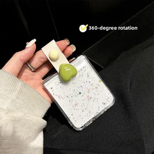Close-up of the 360-degree rotating leather strap with a green heart on the glitter phone case