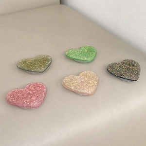 Glittery heart-shaped collapsible phone socket grip in five assorted sparkling colors