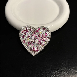 Detail of heart phone grip with colorful star sequins and sparkling rhinestone edge