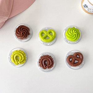 Detail of creative resin cookie and chocolate shaped phone grip sockets with base