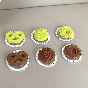 Detail of 6 creative cookie phone stands in green and chocolate brown with gift bases
