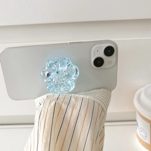 Iridescent blue cat paw phone socket holder with glitter on a white smartphone