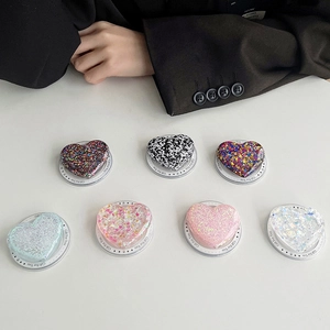 Detailed flat lay of magnetic MagSafe heart-shaped phone grips in seven glitter finishes