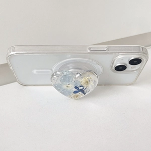 Transparent heart phone grip with blue dried flowers and silver foil on MagSafe case