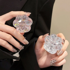 Close-up of cat paw phone grips with sparkling sequins and glitter in hand
