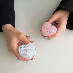 Detail of pink and blue glitter heart phone grips with 'Gift For You' text