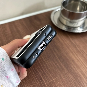Close-up of precise cutouts for charging port and speaker on leather folding phone case