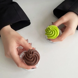 Detailed top view of chocolate and matcha cream cookies used as creative phone sockets