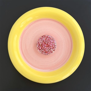 Detail of round phone socket featuring sparkling red and pink glitter inside clear resin