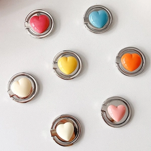Flat lay view of heart-shaped phone ring holders in seven vibrant glossy colors