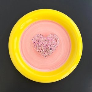 Detail view of heart-shaped phone grip with pink glitter and sequins inside