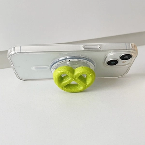 Detail view of a green realistic pretzel phone grip on a transparent phone case