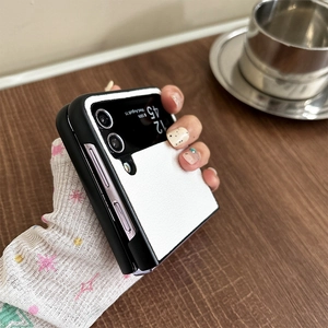 Close-up of a premium black and white leather flip case for a foldable smartphone