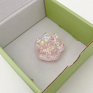 Detail of pink cat paw phone grip with colorful sequins and laser glitter effect