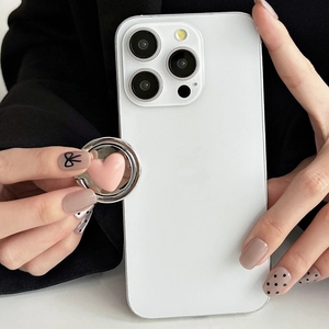 Close-up of a stylish pink heart phone ring holder mounted on a white smartphone