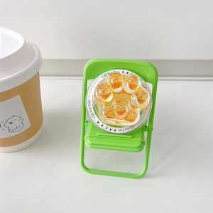 Détail du support téléphone patte de chat ambre pailleté sur mini chaise néon