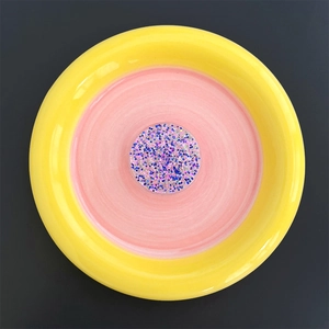 Macro view of a round glitter phone socket with vibrant blue and pink sparkling sequins