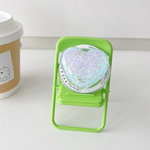 Macro view of purple glitter heart magnetic phone socket on a mini green chair