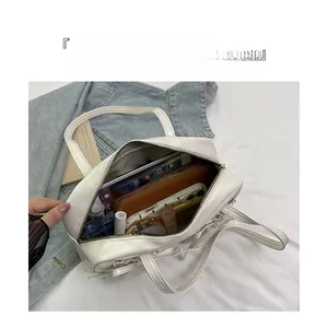 Top view of white leather tote bag interior showing spacious storage for daily essentials