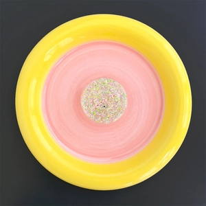 Close-up of a circular phone grip holder featuring vibrant colorful glitter sequins detail