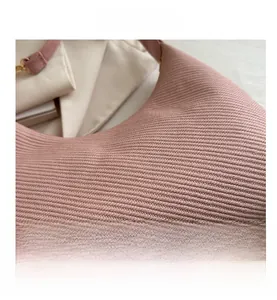 Close-up of pink knitted bag showing detailed 3D twill weave texture and high-quality fabric