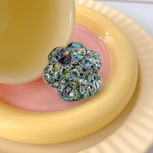 Macro shot of 3D cat paw phone grip with colorful holographic sequins and glitter