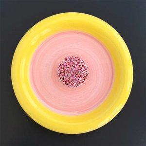 Close-up of heart-shaped glitter inside a yellow and pink telescopic phone socket