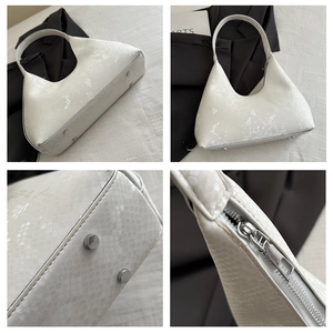 Close-up of snake embossed leather texture and silver zipper detail on the moon bag