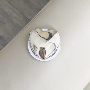 Detail of silver heart phone socket with wavy edges on MagSafe magnetic stand