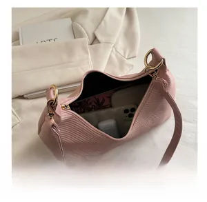 Detail view of pink crossbody bag showing spacious interior with phone and wallet