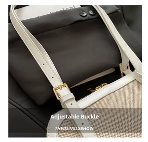 Close-up of golden adjustable buckle on woven shoulder bag with white leather strap