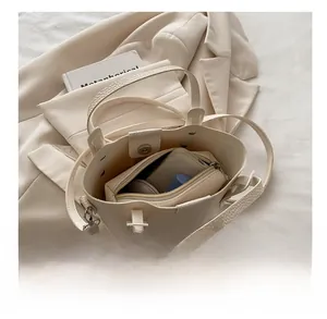 Internal view of beige bucket bag showing large capacity and matching inner pouch