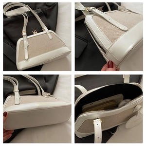 Detailed view of beige canvas and PU leather shoulder bag with gold hardware and interior space