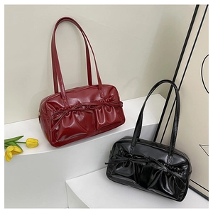 Close-up of retro glossy leather handbags with stylish double bow pocket details