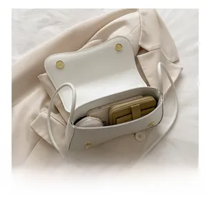 Interior view showing the large capacity for mobile phone and wallet in this white bag