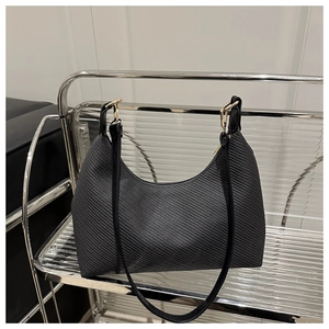 Detail of black woven hobo bag with sleek gold zipper and metallic buckle connector