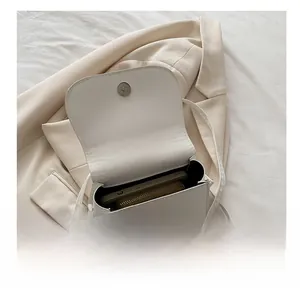 Detail view of white leather crossbody bag interior showing spacious storage capacity