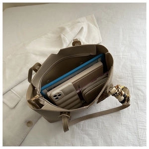 Spacious khaki tote interior showing tablet, wallet, and phone organized on white fabric