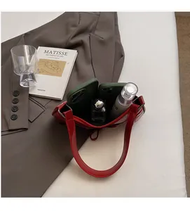 Internal view showing the practical storage capacity of this bright red glossy handbag