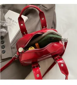 Interior view of red oil wax leather handbag showing large capacity for phones and lipstick