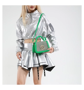 Detailed view of green retro crossbody bag with herringbone fabric and golden clasp