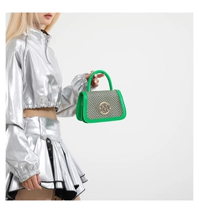 Detail of green leather tote bag with houndstooth flap and gold letter M buckle